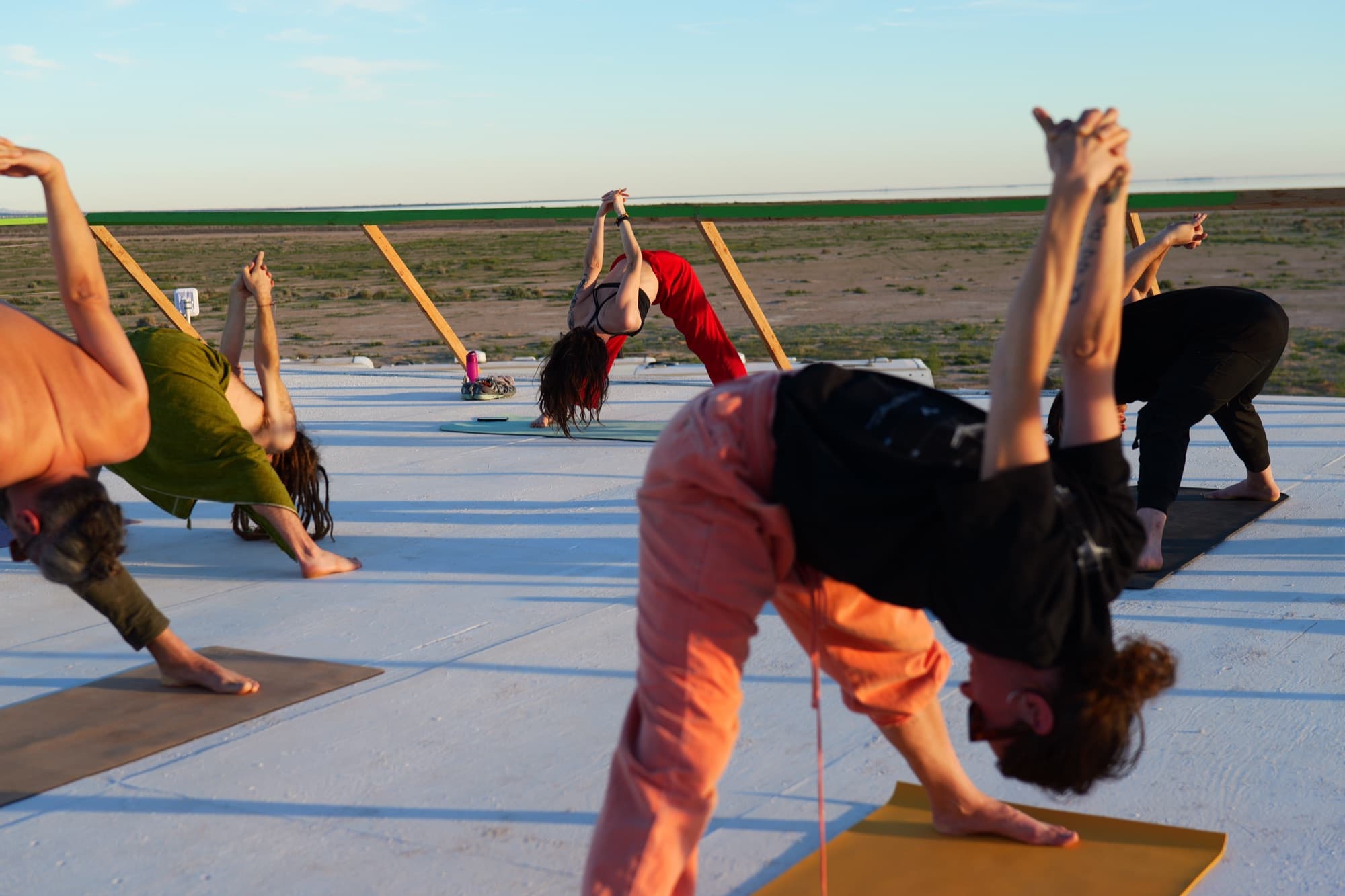 A class in side-angle stretches on the rooftop, Julia in the middle
